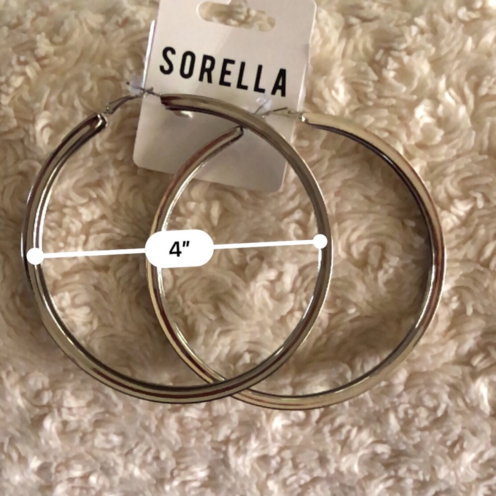 Hoop fashion earrings. Silver color. 4”. Sleek finish